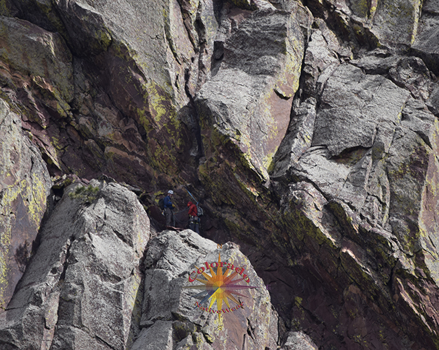 A couple of rock climbers hanging out on a ledge in Eldorado Canyon State Park Colorado
