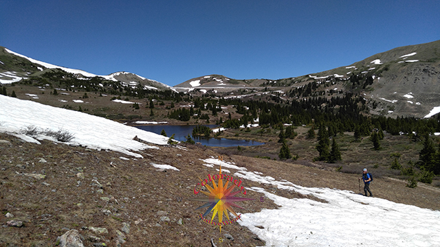 Entering a patchy snow field, enjoying the view looking back Lost Lake Trail, San Isabel National Forest