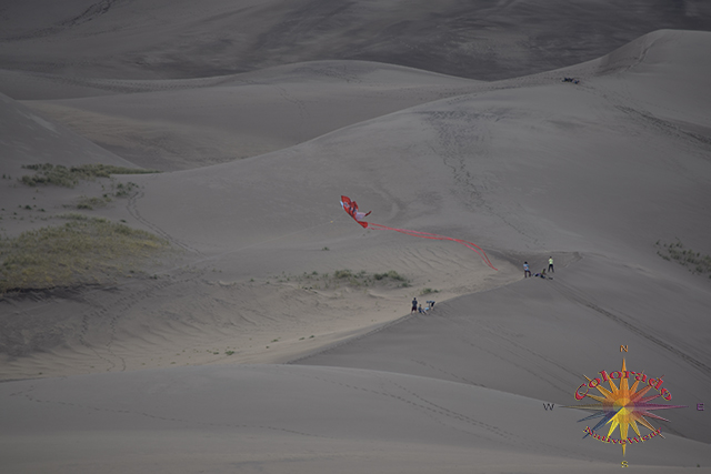 Looking down the dune on People and a kite in Great Sand Dunes National Park Colorado