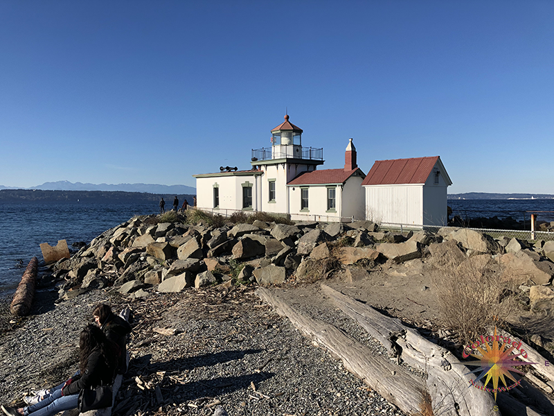 Lighthouse sits out on a rock jetta guiding ships into the harbor