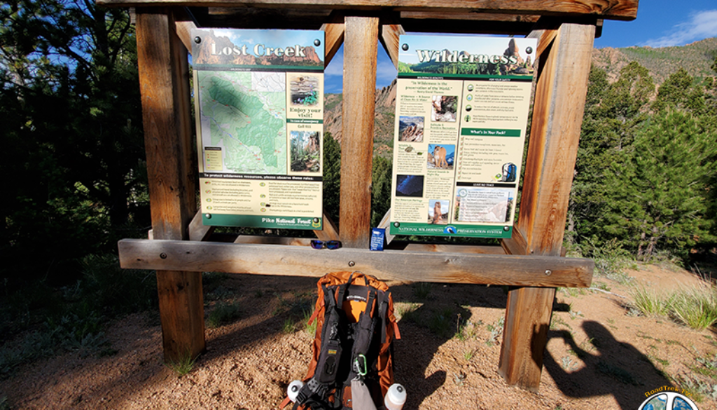 Trail Head sign, Lost Creek Wilderness information with a map. Also showing off my Optic Nerve Sunglasses, a RX Bar and my Osprey Pack.